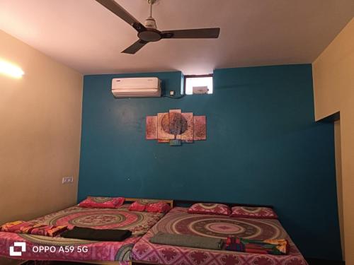 a bedroom with a bed and a blue wall at gokarna beach stay in Gokarn