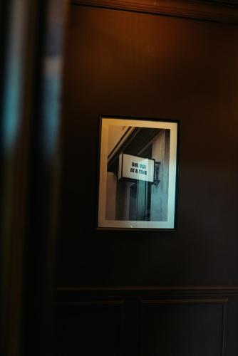 a framed picture of a sign on a wall at Stunning Town Centre Apartments with Spa facilities in Morpeth