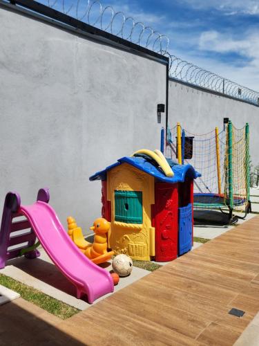 a childrens playground with a slide and a play equipment at Sobrado novo e lindo com piscina in São José dos Campos