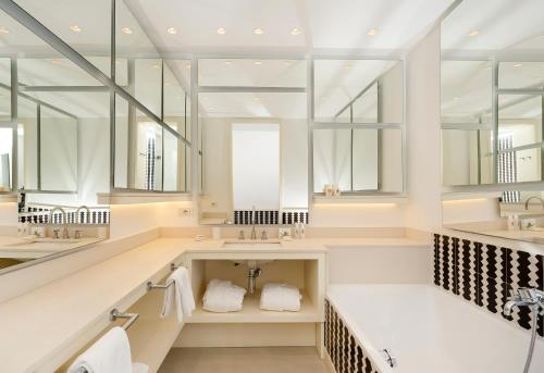 a bathroom with a sink and a large mirror at Relais Blu in Massa Lubrense