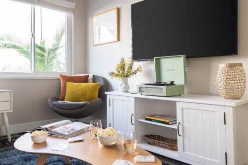a living room with a table and a chair at Seashore Suites by AvantStay Modern Comfort Steps from La Jolla Cove in San Diego