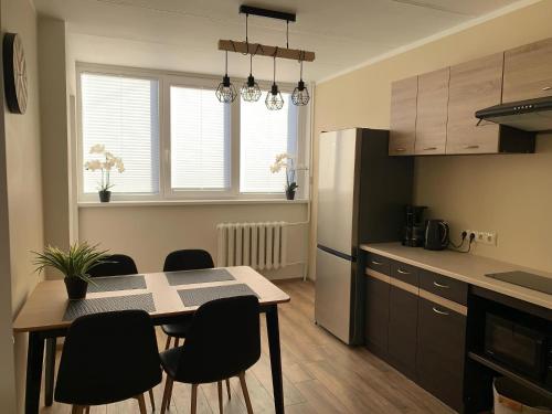 a kitchen with a table and chairs in a room at Leola Apartment in Viljandi