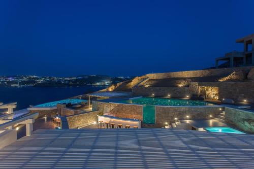a night view of a building with two pools at Villa Sapphire 6bed with Pool and Hot Tub in Ornos in Ornos