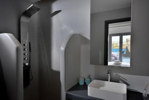 a bathroom with a sink and a mirror at Villa Sapphire 6bed with Pool and Hot Tub in Ornos in Ornos