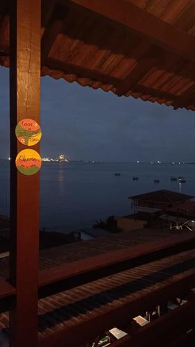 a view of the ocean at night from a building at Pousada Vida Simples in São Francisco do Sul
