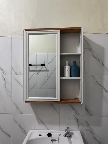 a bathroom with a mirror and a sink at Besakih villa in Besakih