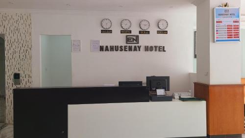 a reception desk with clocks on the wall at Nahusenay hotel in Addis Ababa