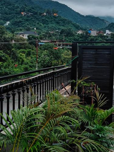 a balcony with a view of a train track at Chakk 109 Mussoorie Foothills, Dehradun in Dehradun