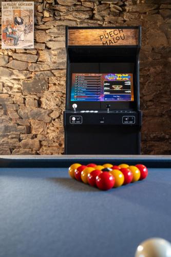 a billiard table with a tv in the background at Domaine du Puech Malou in Teillet