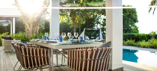 a table with wine glasses on a patio at Dhigali Maldives - A Premium All-Inclusive Resort in Raa Atoll