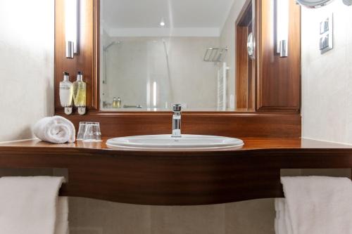 a bathroom with a sink and a mirror at Hotel Haffner Resort & Spa - Destigo Hotels in Sopot