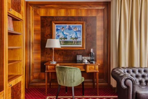 a desk with a lamp and a chair in a room at Hotel Haffner Resort & Spa - Destigo Hotels in Sopot