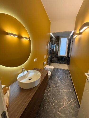 a bathroom with a sink and a large mirror at settala 10 apartments in Milan