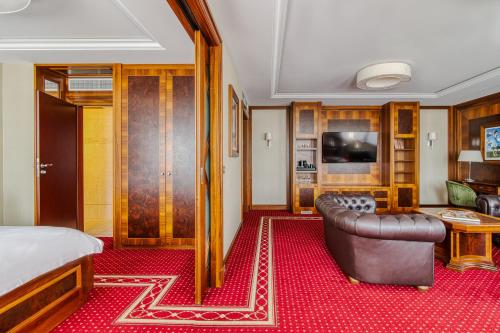 a hotel room with a bed and a couch at Hotel Haffner Resort & Spa - Destigo Hotels in Sopot