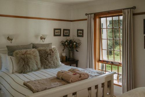 a bedroom with a bed with stuffed animals on it at Forth River Cottage in Forth