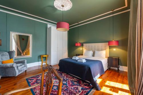 a bedroom with a bed and a chair at Portuguese Charm in Lisbon in Lisbon