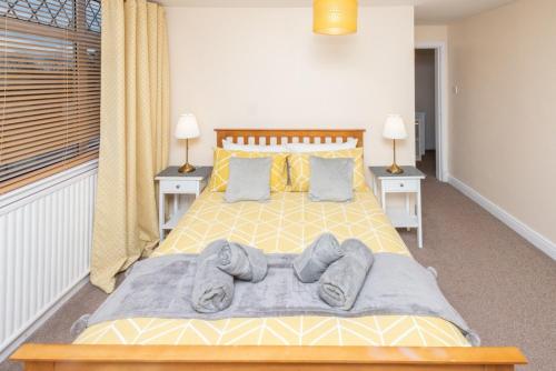 a bedroom with a yellow bed with two night stands at Aberdeen Nest in Aberdeen