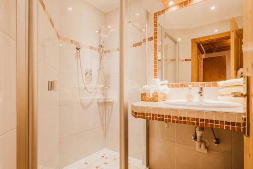 a bathroom with a shower and a sink at HOFERHOF Schladming -Dachstein in Schladming