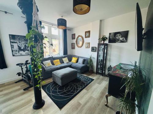a living room with a couch and a table at Charming & Modern Flat 2 in Pontypool