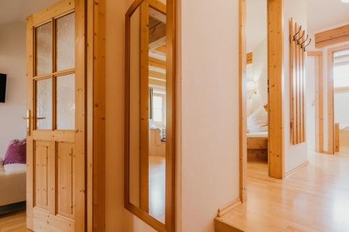 a large mirror in a room with a bedroom at HOFERHOF Schladming -Dachstein in Schladming