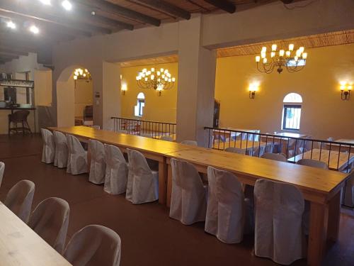 a large wooden table and chairs in a room at Ongegund Lodge in Somerset West