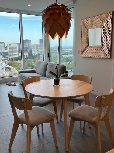 a living room with a table and chairs and a couch at The Podium 2B2B - 50mtr to ACCOR in Sydney