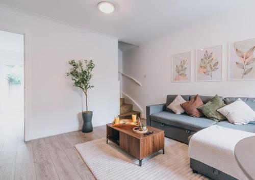 a living room with a couch and a coffee table at The Bay Hideaway - Lovely 2bd house - up to 6 people in Cardiff