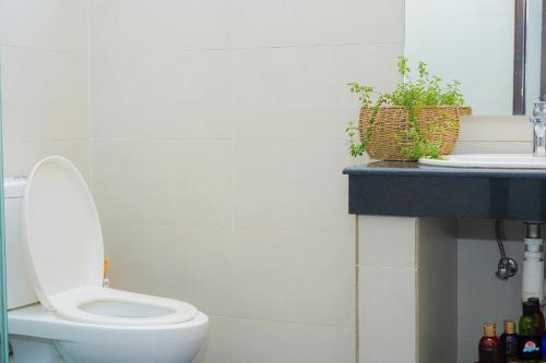 a bathroom with a white toilet and a sink at Beach Symphony in Mount Lavinia