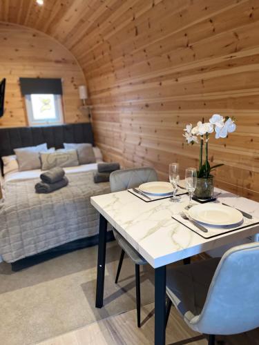 a dining room with a table and a bed at Willow Nook, near Saundersfoot and Tenby in Saundersfoot