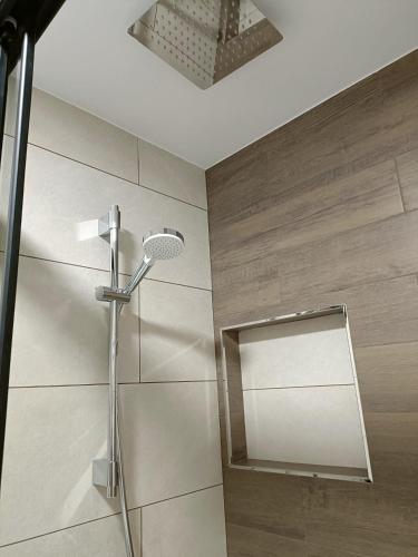 a bathroom with a shower and a mirror at O nido do cuco in Muxia
