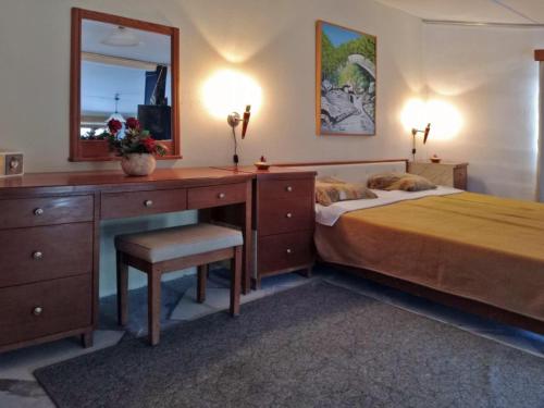 a bedroom with a bed with a desk and a mirror at Παραδοσιακό σπιτι frozen in Elefterna