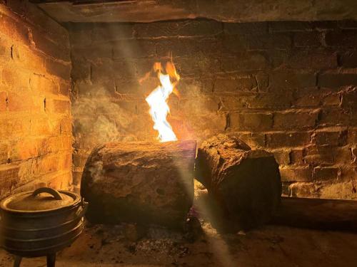 a brick oven with a pot and a fire at Buckswood Hilltops in Stegi