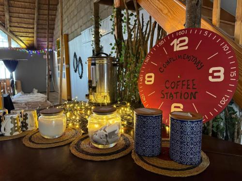 a table with lights and jars and a clock at Buckswood Hilltops in Stegi