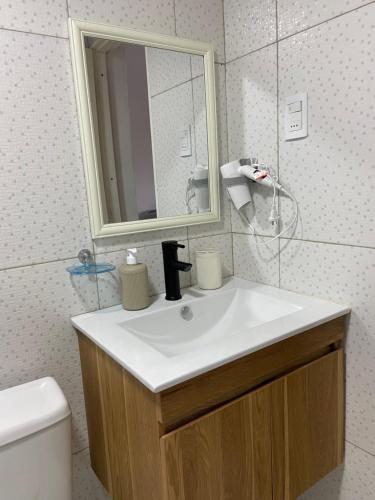 a bathroom with a white sink and a mirror at Leo in Punta del Este