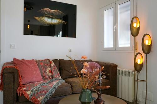 a living room with a couch and a table at Apartamentos Dos Carneros in Alhaurín de la Torre