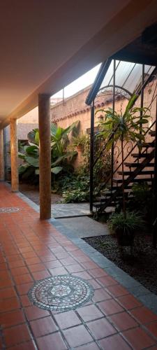 a building with a patio with stairs and plants at Hostel Salta por Siempre in Salta