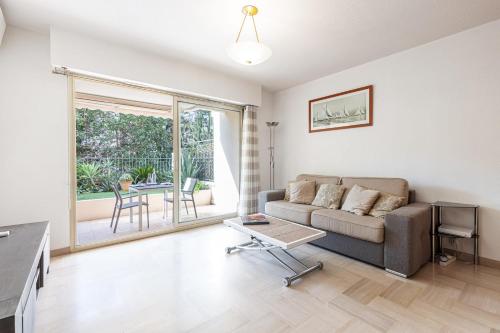 un salon avec un canapé et une table dans l'établissement Central Terrace Garage & AC, à Cannes