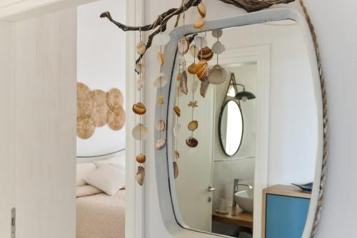 a mirror in a bedroom with shells on the wall at Casa Melete - Goelba in Seccheto