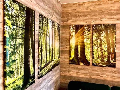 two paintings of trees on a wall at Lieblingsstück in Tanne
