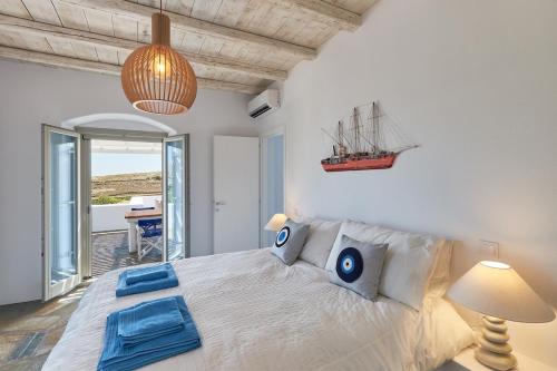 a bedroom with a bed with a ship on the wall at Villa Okyalos - Purely Greek in Livadia