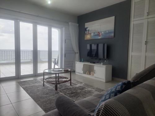 a living room with a couch and a table and a television at Nomads Nook 15 in Ramsgate