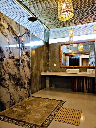 a bathroom with a sink and a mirror at Baan Tropicana in Mae Nam