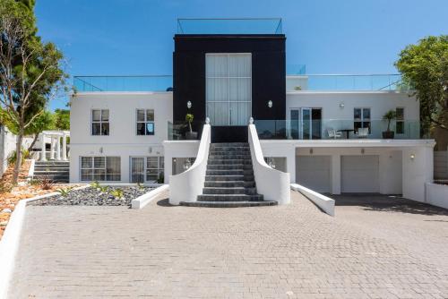 a white building with a staircase in front of it at Bed and Breakfast Villa Livadia in Cape Town