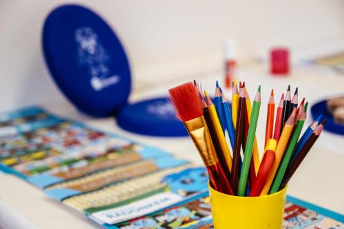 a cup filled with colorful pencils on a table at Hotel Astoria in Jáchymov