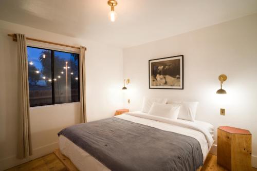 a bedroom with a large bed and a window at Alamo Motel in Los Alamos