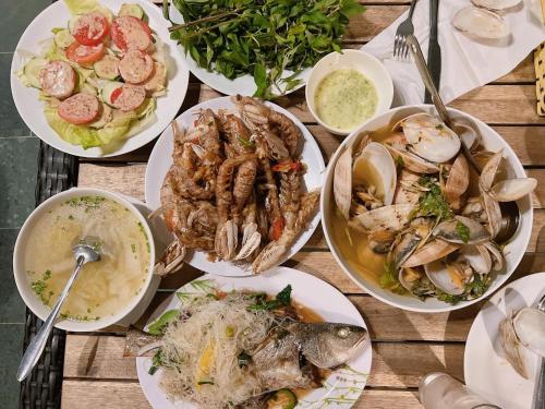 a group of plates of food on a table at Paradise Resort Doc Let - All Inclusive in Doc Let