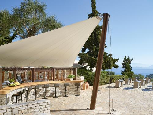 a large white tent in front of a building at Grecotel LUXME Daphnila Bay in Dassia