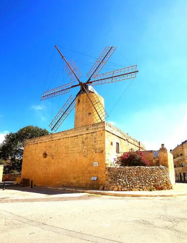 a windmill on the side of a brick building at Traditional Farmhouse Central Gozo in Xagħra