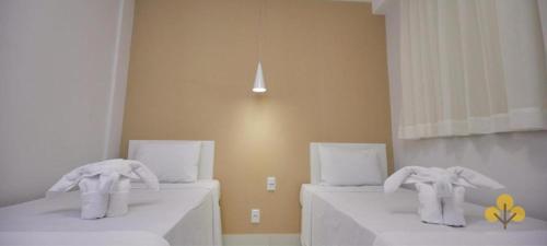 two towel elephants sitting on beds in a room at Resort do LAGO - Caldas Novas in Caldas Novas