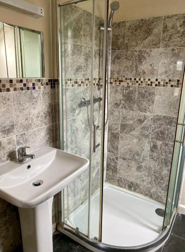 a bathroom with a sink and a shower at Fieldways in Trowbridge
